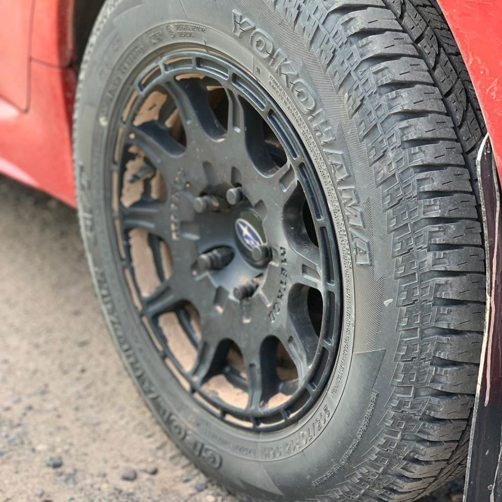 method racing wheels and rally armor mudflaps on subaru wrx with lift kit