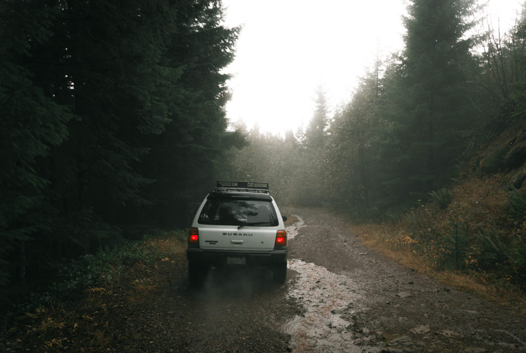 Lifted Subaru Forester on a gravel road with all terrain tires.