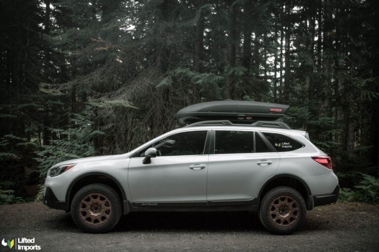lifted subaru outback on method race wheels in the forest on all terrain pirelli tires