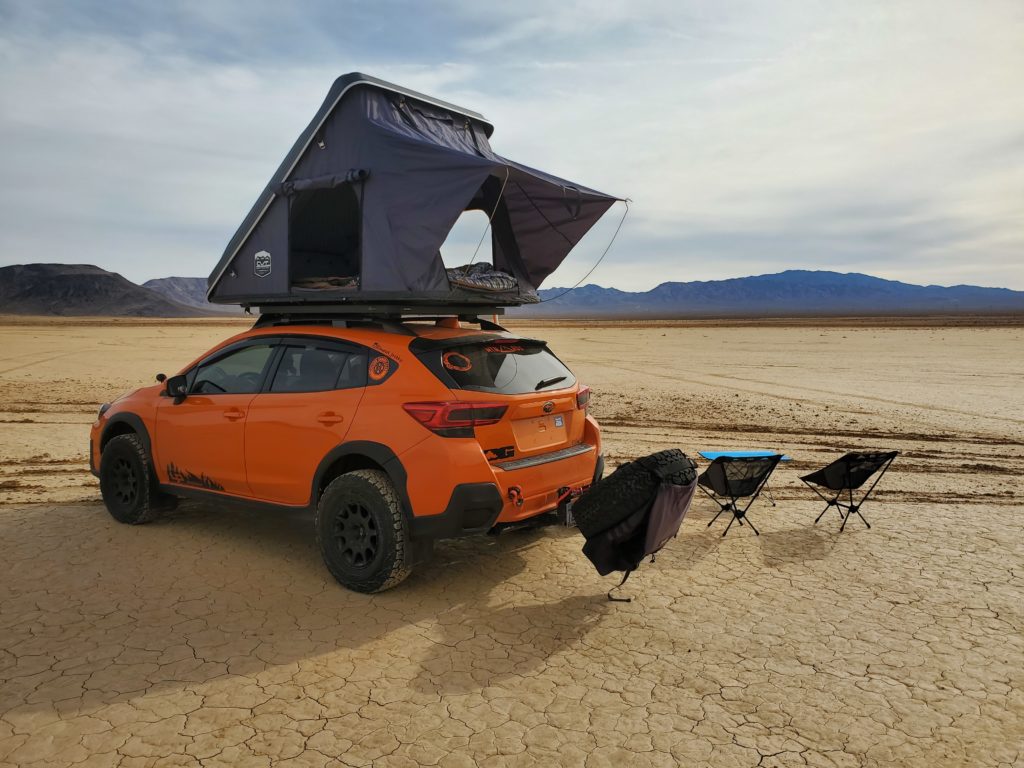 subaru crosstrek in the desert with all terrain tires and off road gear