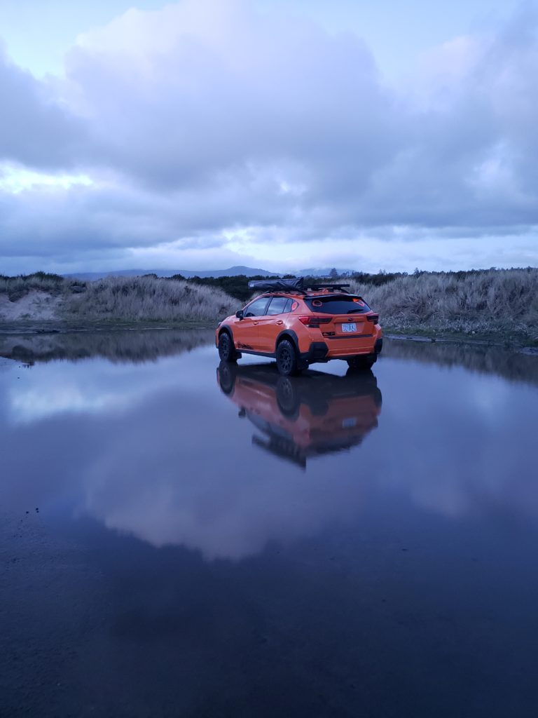 subaru crosstrek with lift kit and off road gear in the water