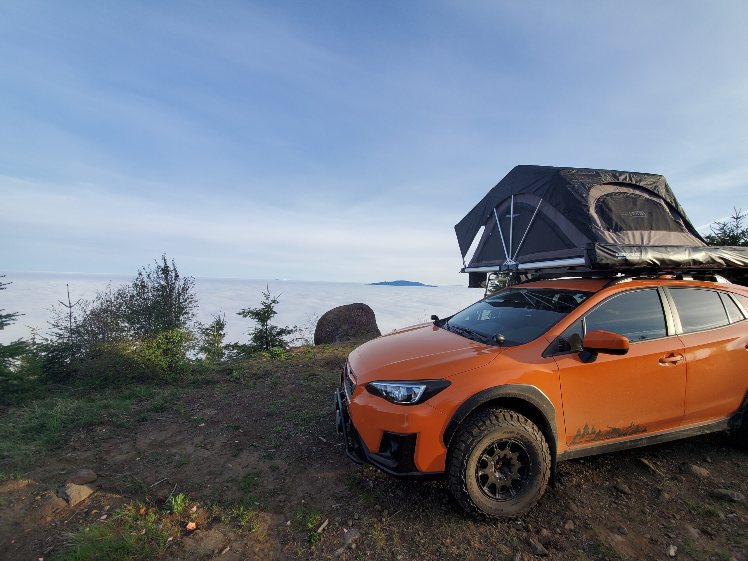 Subaru crosstrek lifted in orange with roof tent