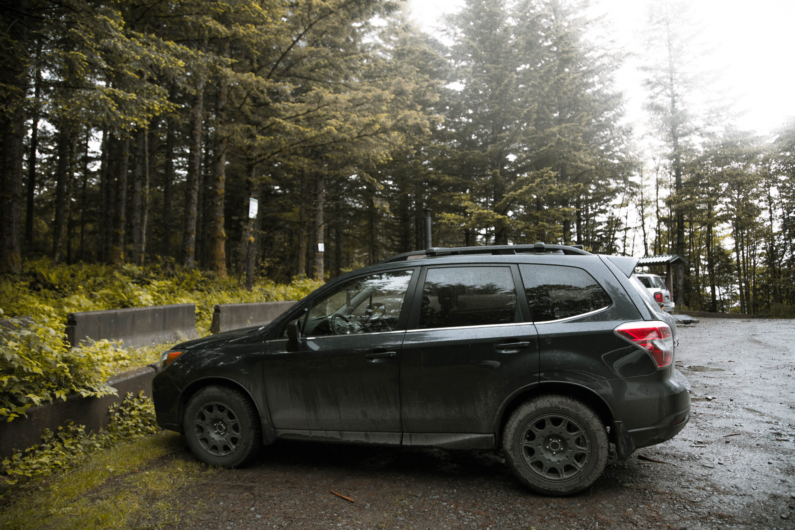 lifted subaru forester with all terrain big tires on a lift kit