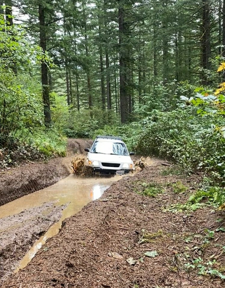 mud terrain tires on subaru forester in the woods