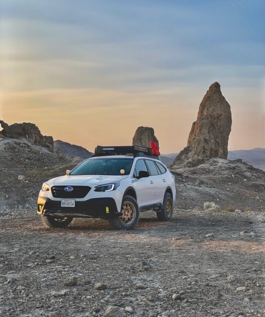 lifted subaru outback on lp aventure heels in the forest on all terrain pirelli tires