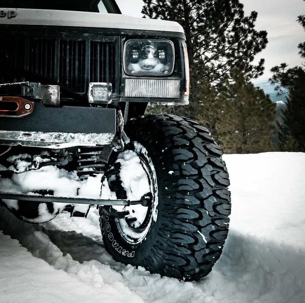 lifted jeep with mud terrain tires in snow