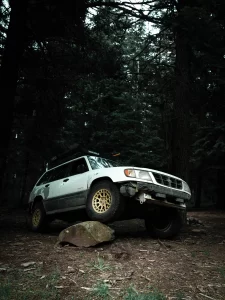 lifted subaru forester with all terrain tires flexing off road after lift kit install