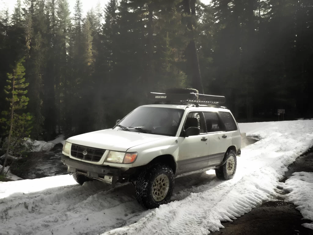 lifted subaru forester in the snow with off road tires and lift kit