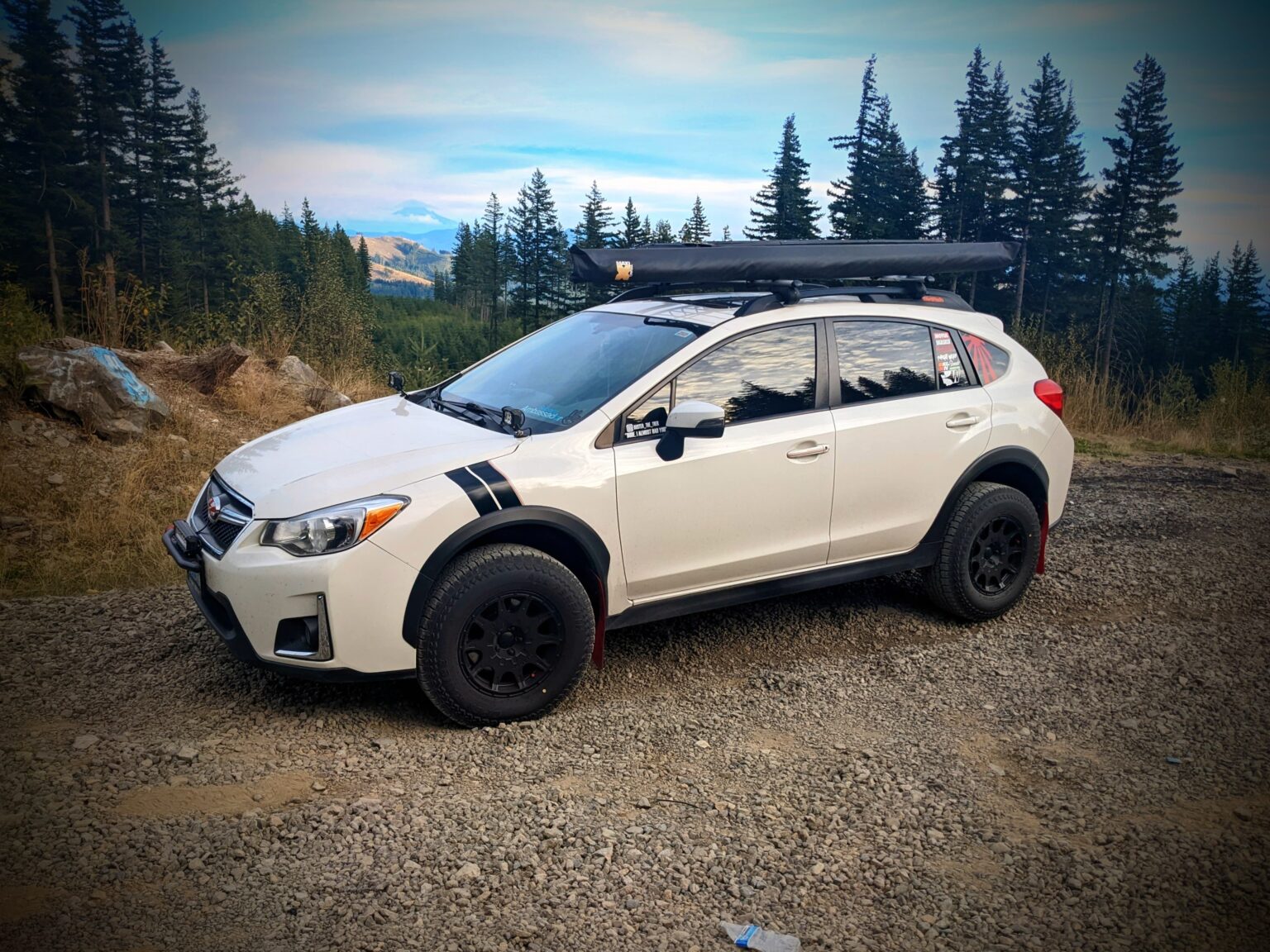 2016 subaru crosstrek lifted with offroad tires and wheels in the forest