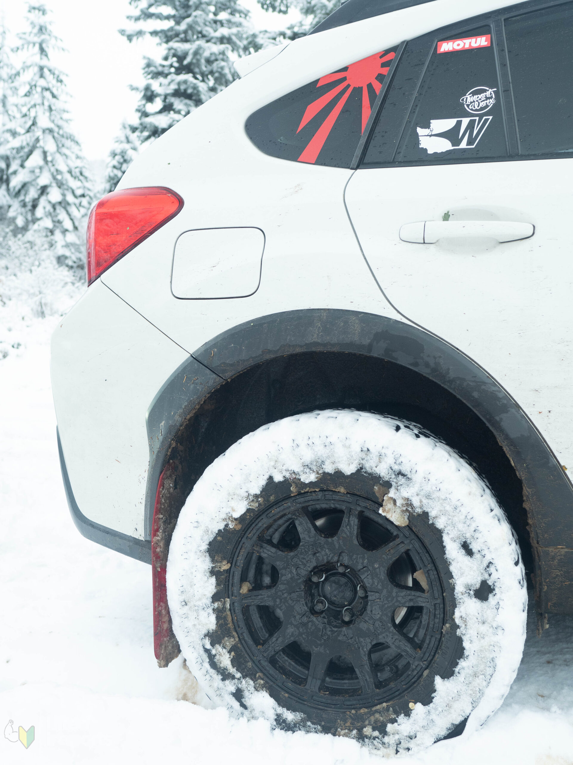 white lifted subaru crosstrek with offroad tires and method mr502 wheels in the snow