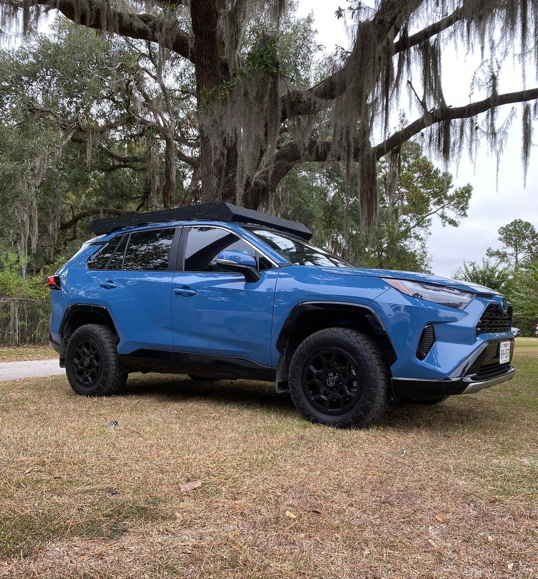 lifted blue rav4 2022 hybrid with offroad wheels and tires and readylift lift kit