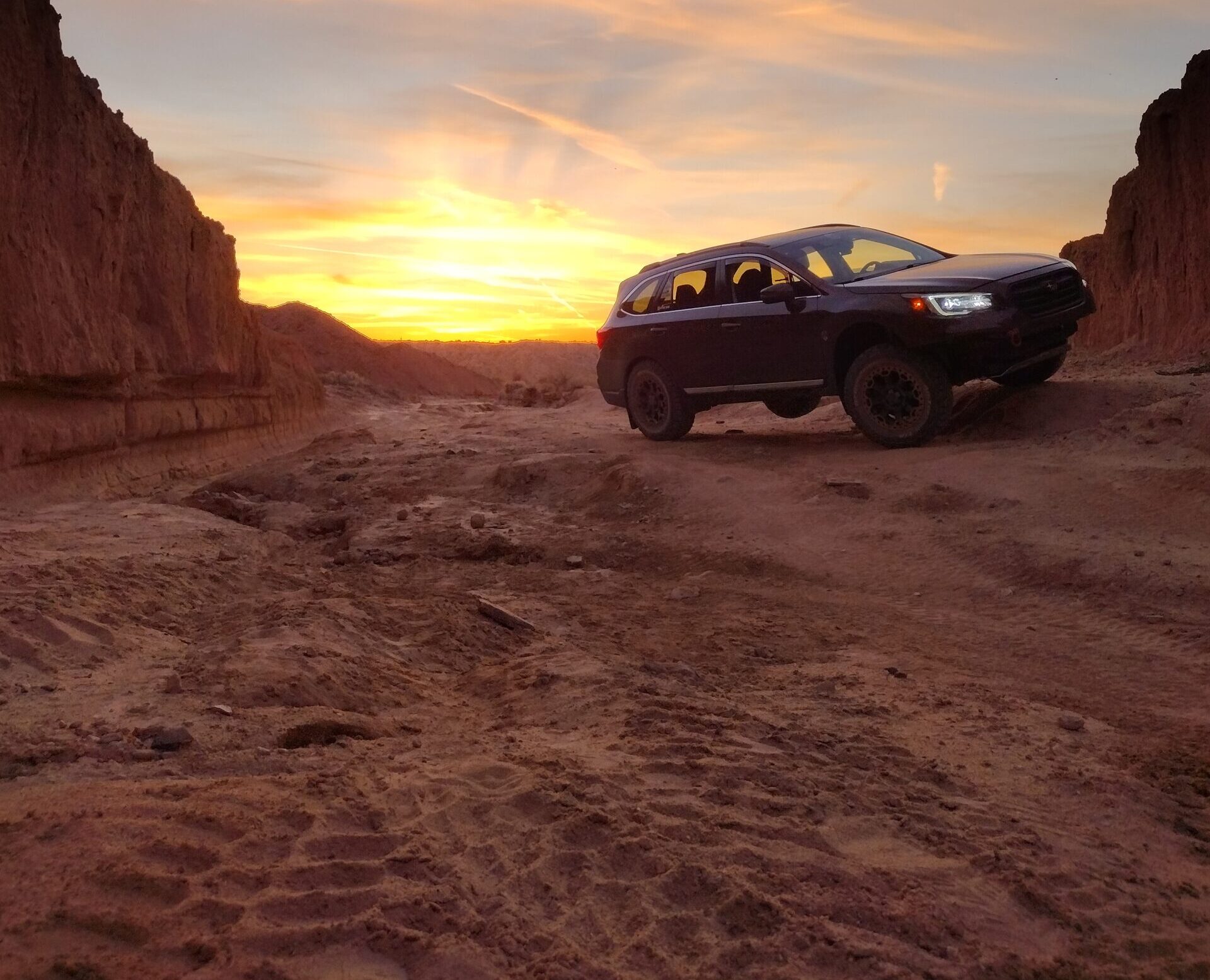 subaru outback 36R with lift kit and offroad tires beautiful sunset