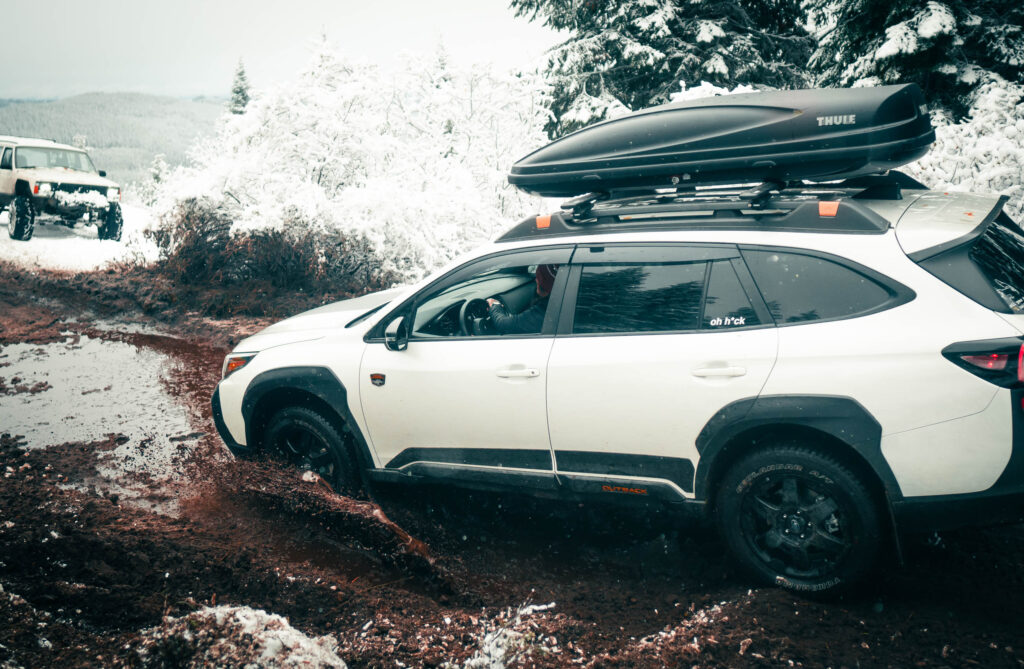 subaru outback in the snow and mud with all terrain tires