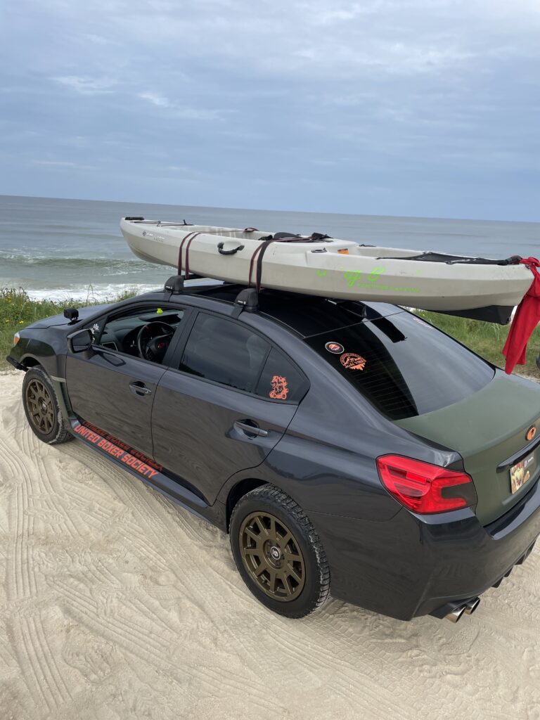 lifted wrx with kayak on roof