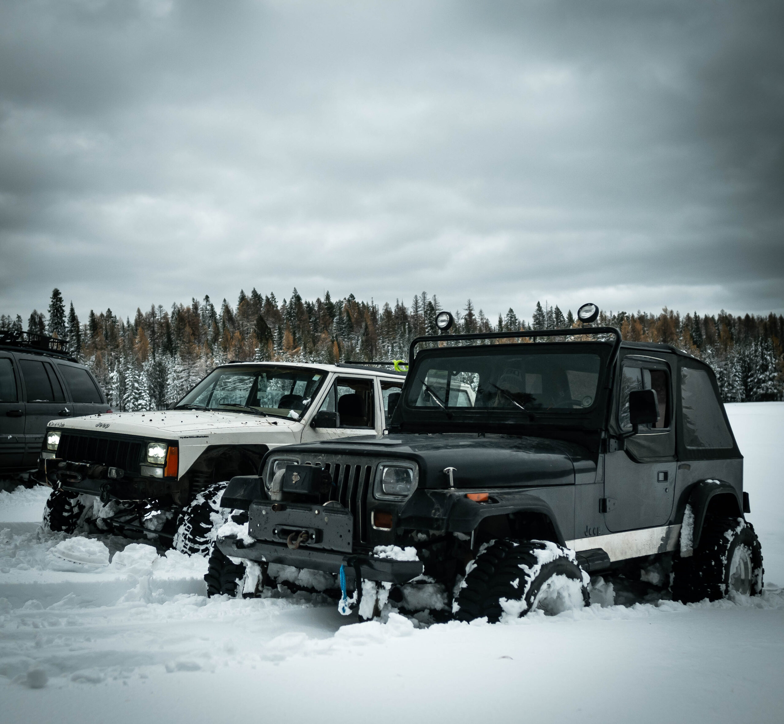 two lifted jeeps in deep snow