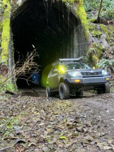 lifted subaru forester in a forest tunnel