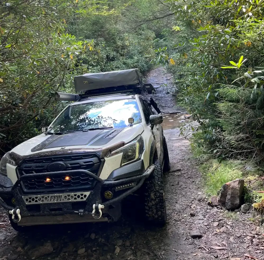 modified offroad subaru forester wilderness edition with rooftop tent