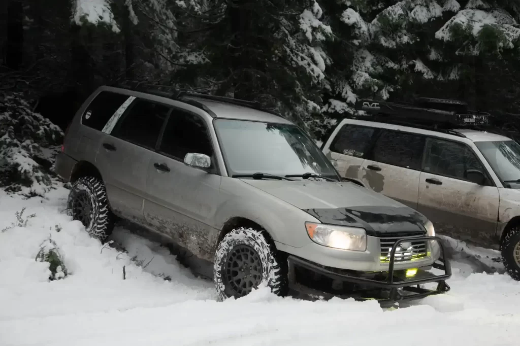 lifted subarus in the forest with snow tires and offroad tires
