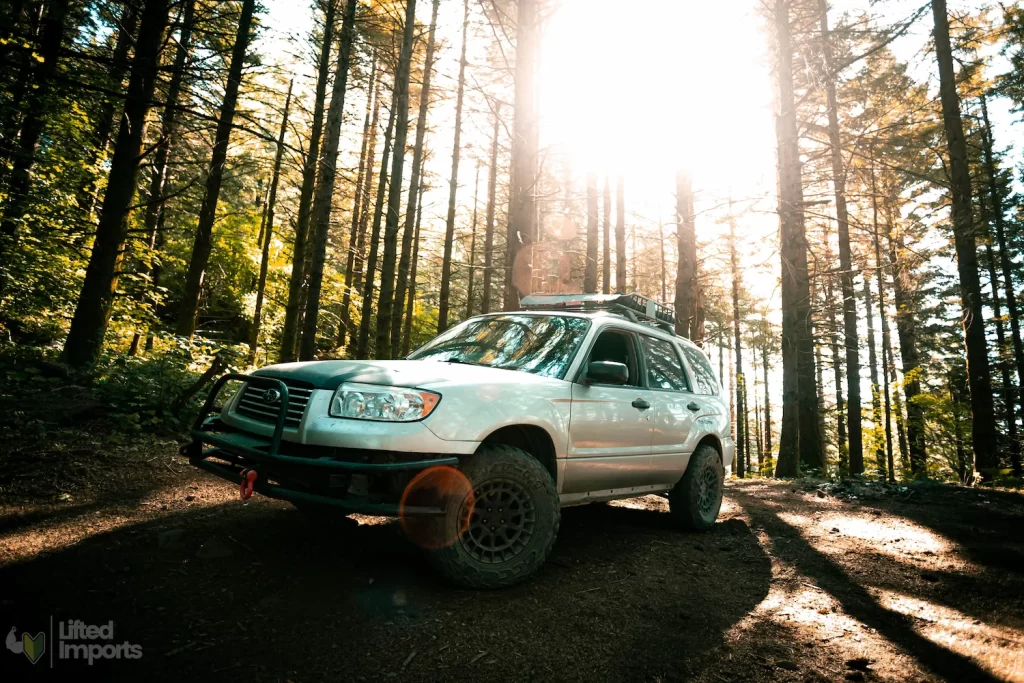 2006 lifted subaru forester in the woods with black rhino boxer wheels