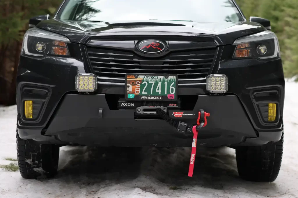 2021 Subaru forester offroad in the snow lifted with warn winch bumper