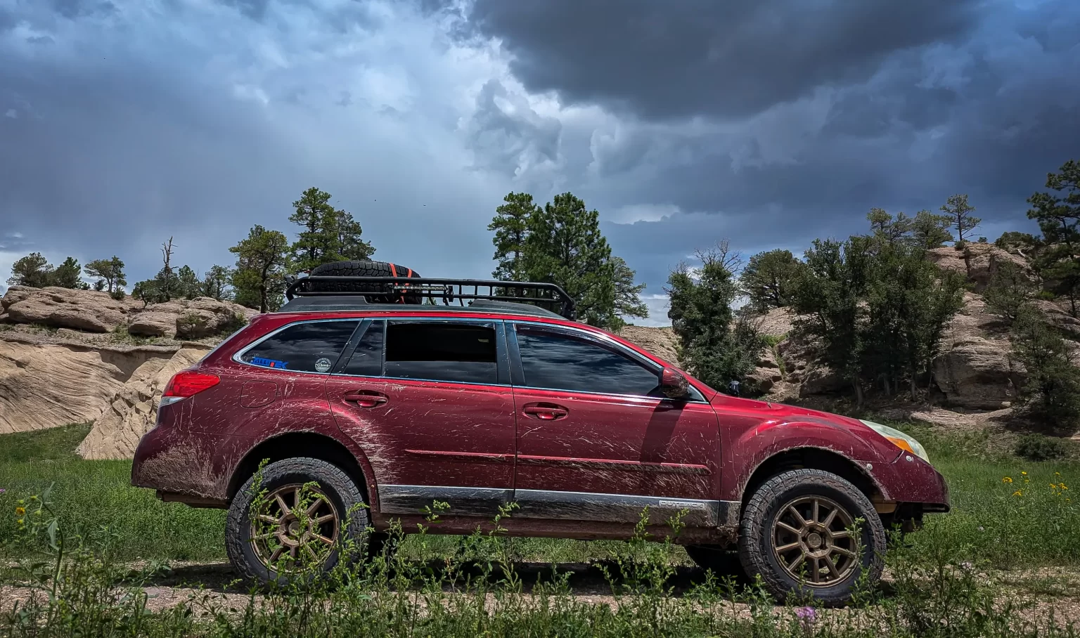 red subaru outback 3.6R with lift kit and offroad tires